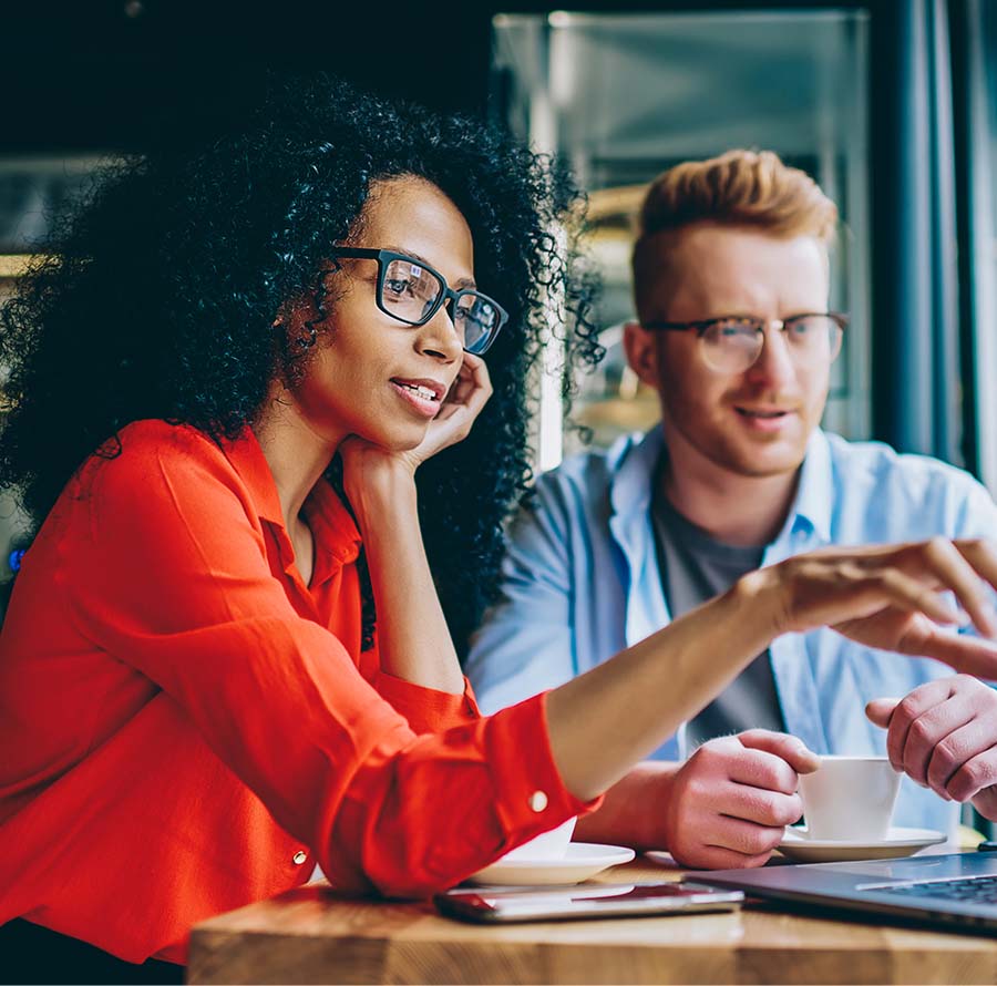 woman and man looking at laptop and woman is pointing at screen