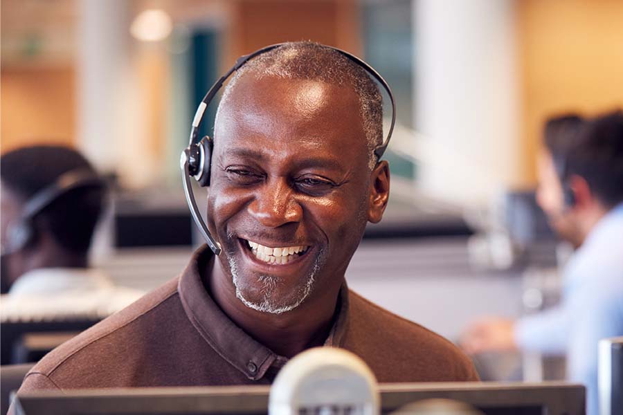 Man smiling while wearing a headset